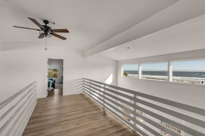 This walkway with stunning ocean views connects the two upstairs bedrooms.