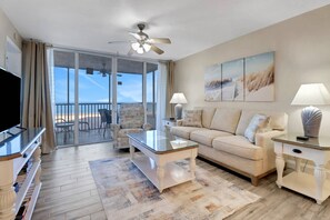 A large sliding glass door opens onto the fully screened lanai, filling the space with sunlight.