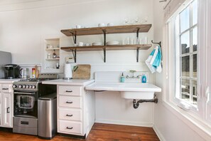 Kitchen with full-size refrigerator/freezer, oven/range. 