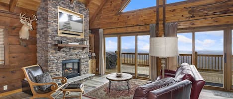 Living Room With Stone Fireplace and TV