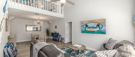 Entrance into house, living area and stairs to loft and bedroom