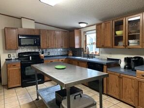 Refrigerator, stove with oven, dishwasher and two microwaves. Coffee bar area.