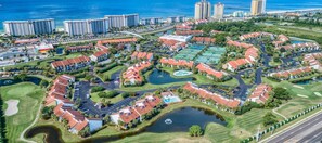 Drone image of the resort from the back, showing the villas and golf course. 