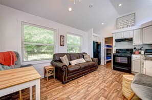 Living Room/Kitchen view from the front door(couch turns into a Queen Sized Bed)