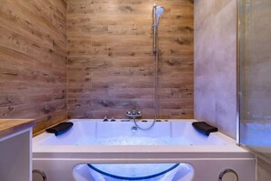 Hydromassage bathtub in the bathroom.