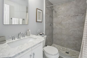 Elegant master ensuite, features a white marble vanity sink