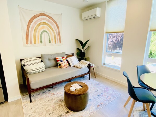 Cute living room with air conditioner and cozy sofa bed!