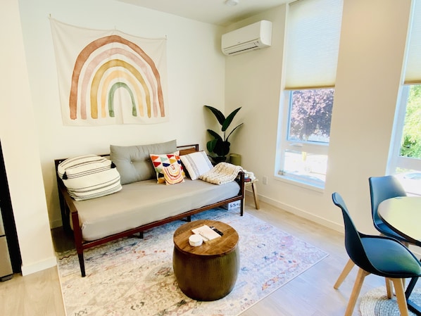 Cute living room with air conditioner and cozy sofa bed!