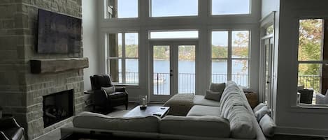 Large 2 story family room overlooking the lake with shuffleboard table. 