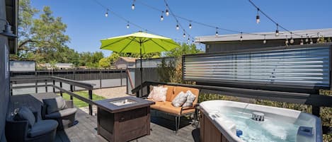 firepit and hot tub on back porch
