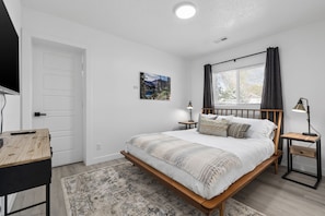 Bedroom #1 - w/private bathroom, TV, and queen bed.