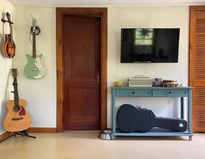 View of TV from couch. Bathroom door.