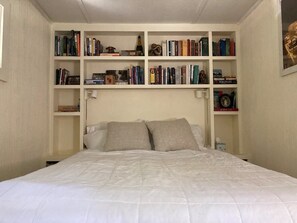 Queen-size bed with built-in bookcases and drawers.