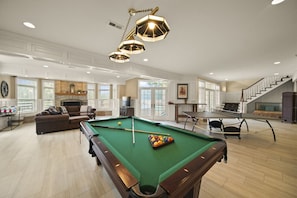The walkout lower level game room and entertainment center is where everyone always ends up
