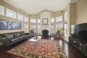 Make memories by the fire in the family room with gorgeous floor-to-ceiling windows
