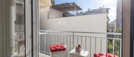 Bright kitchen-dining area with afternoon and evening sun and small balcony