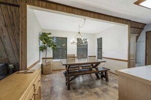 The dining area at Larkspur Lodge offers a cozy, inviting space perfect for enjoying family meals or gathering for board games and card nights. With plenty of seating and natural light, it’s the heart of the home for making lasting memories together. 