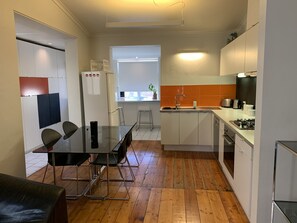 Dining, kitchen with work area and a view to the rear garden