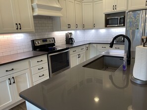 Beautiful kitchen has everything you need for preparing and eating your meals