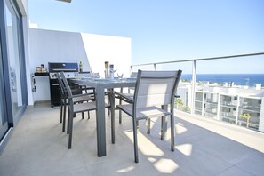 Balcony with dining table and BBQ