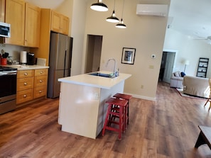View of kitchen and living room as you enter the apartment.