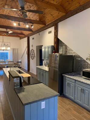 The large kitchen has full sized cutting board and bluestone food prep areas.