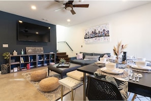 Enjoy the living/dining room with a 75” Smart TV, board games, and local art.