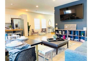 Enjoy the living/dining area with a 75” Smart TV, board games, and local art.
