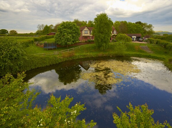 The cottage from behind the lake. The main bedroom window is in view
