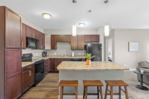 The open kitchen with seating at the eat-in counter (additional stools are available).