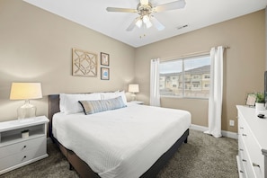 The primary bedroom with 12" king mattress, room darkening curtains, smart tv and more!