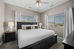 The primary bedroom with an ultra plush, 12" memory foam king-sized mattress.  There are room darkening curtains, dresser, en suite bathroom, smart TV and more.