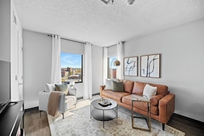 The living room is cozy, spacious, offers plenty of seating for everyone and exceptional views of Des Moines.