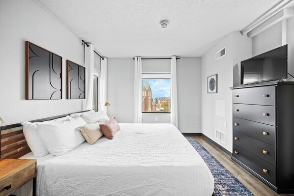The comfy, king sized bed with dresser, smart TV, room darkening curtains and more!