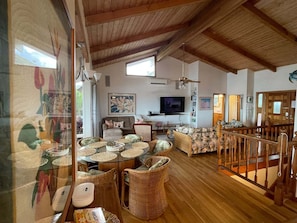 High beam ceiling, hardwood floors, & 70” tv make for an inviting living space!
