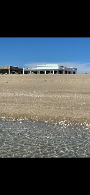 Standing in the ocean facing patios