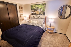 Primary Bedroom with queen sized bed. Storage available in dresser and closet.