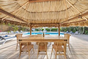 Enjoy the fresh air and sunshine while dining al fresco at this outdoor seating area featuring a BBQ grill