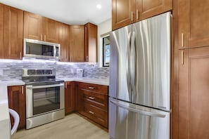 Kitchen offers stainless-steel stove, microwave, dishwasher and refrigerator.