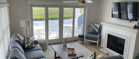 Family room with bay views, gas fireplace, and 55in TV.