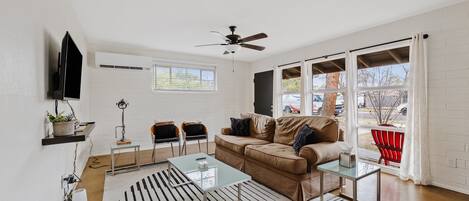 Hang out and socialize in this modern living room equipped with a 43" TV, sleeper sofa and chairs!