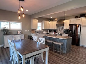 Open concept gourmet kitchen and dining area overlooking the Black River.