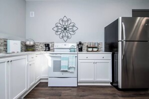 Full size kitchen appliances including a dishwasher for your convenience.
