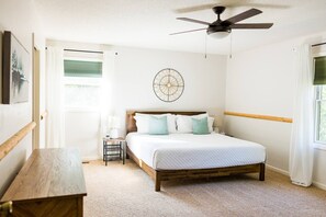 Master bedroom with king sized bed, tv with chromecast, and private bathroom with shower and walk in closet.