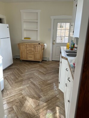 Kitchen w island to move with expansion for two stools 