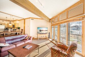 Cozy family room with great natural lighting and mountain views and access to deck