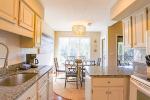 The spacious kitchen opens onto the sunny dining area.