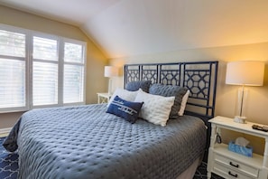 The master suite has a king bed and night stands with reading lamps.
