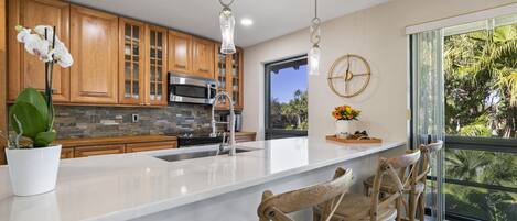 Stunning renovated kitchen. A social space at the quartz countertop.