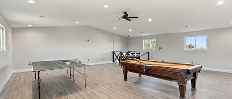 Entertainment game room with ping pong, pool table and smart TV